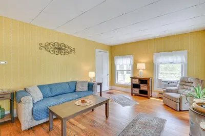 a living room with a blue couch and a table at Countryside Hideaway - 10 Mi to Cooperstown! in Westford