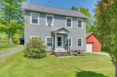 a gray house with a red shed in the yard at Countryside Hideaway - 10 Mi to Cooperstown! in Westford