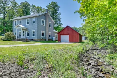 a house and a red barn at Countryside Hideaway - 10 Mi to Cooperstown! in Westford