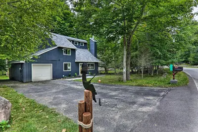 a house with a horse statue in front of it at Relax Fireside! Retreat 15 Mi to Camelback Slopes in Tobyhanna