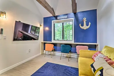 a living room with a yellow couch and chairs at Relax Fireside! Retreat 15 Mi to Camelback Slopes in Tobyhanna