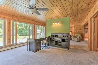 a home office with a desk and a ceiling fan at Riverside Retreat in Catskill Mountains with Pool, Hot Tub & Game Room in Starlight