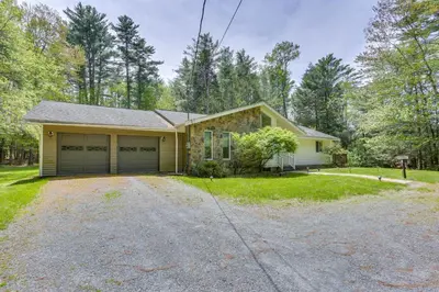 a house with a garage and a driveway at Cozy Swan Lake Apt with Grill and Private Yard in Swan Lake