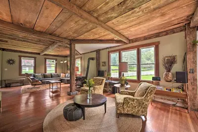 a living room with wooden ceilings and a table and chairs at Game Room and Fire Pit Peaceful Catskills Farmhouse in Treadwell