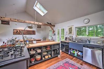 a kitchen with a sink and a stove top oven at Game Room and Fire Pit Peaceful Catskills Farmhouse in Treadwell