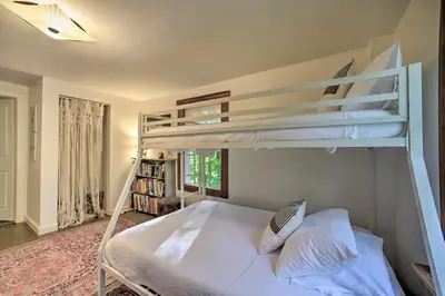 a bedroom with two bunk beds and a book shelf at Game Room and Fire Pit Peaceful Catskills Farmhouse in Treadwell