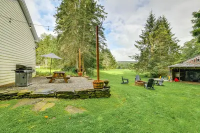 a backyard with a picnic table and a fire pit at Game Room and Fire Pit Peaceful Catskills Farmhouse in Treadwell