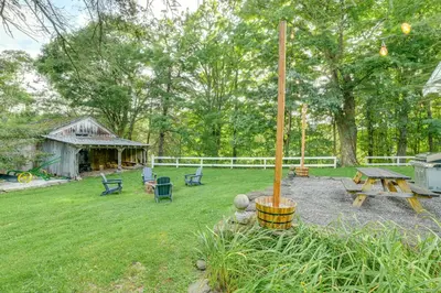a backyard with a picnic table and a grill at Game Room and Fire Pit Peaceful Catskills Farmhouse in Treadwell