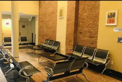 a room with chairs and tables and a brick wall at Hansem stay near Empire State Building in New York