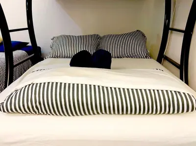 a bed with black and white pillows on it at Hansem stay near Empire State Building in New York