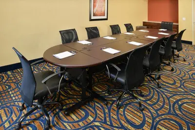 a conference room with a long table and chairs at Holiday Inn Express & Suites Peekskill-Lower Hudson Valley by IHG in Peekskill