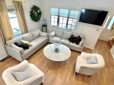 a living room with a couch and two chairs and a table at Cozy 4BR 3BA Home- Train to NYC, USOpen, CitiField Mets, MSG, Walk to Harbor & Golf in Port Washington