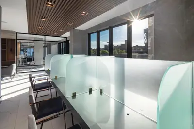 a lobby with chairs and tables and windows at Global Luxury Suites at The Arches in Bronx