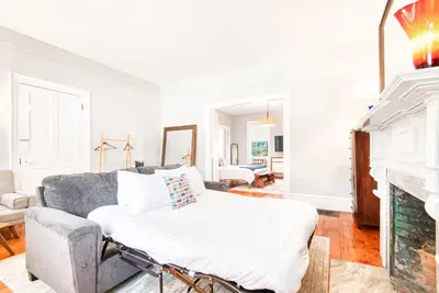 a living room with a couch and a fireplace at Hudson Mariner in Hudson