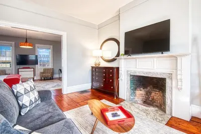 a living room with a fireplace with a tv above it at Hudson Mariner in Hudson