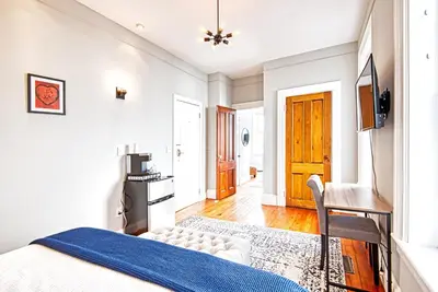 a bedroom with a bed and a chair in it at Hudson Mariner in Hudson