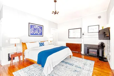 a bedroom with a bed and a fireplace at Hudson Mariner in Hudson