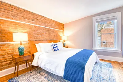 a bedroom with a bed and a brick wall at Hudson Mariner in Hudson
