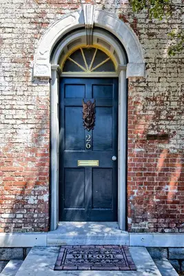 a blue door on a brick building with a lion on it at Hudson Mariner in Hudson
