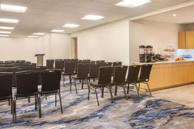 a conference room with chairs in a room with a counter at Fairfield by Marriott Inn & Suites Rockaway in Rockaway