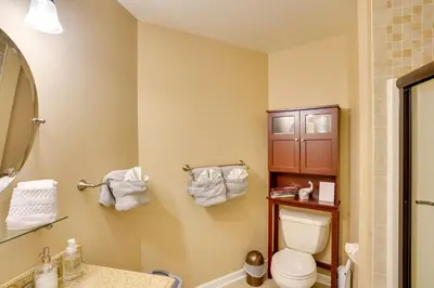 a bathroom with a toilet and a sink and a mirror at Expansive Upstate Home with Home Theater! in East Schodack