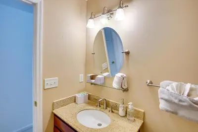 a bathroom with a sink and a mirror at Expansive Upstate Home with Home Theater! in East Schodack