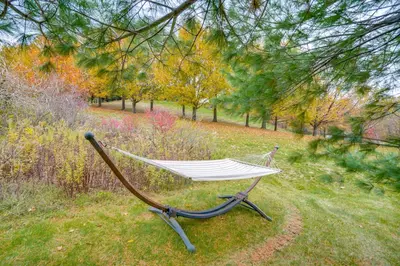 a hammock sitting in the grass in a park at Expansive Upstate Home with Home Theater! in East Schodack