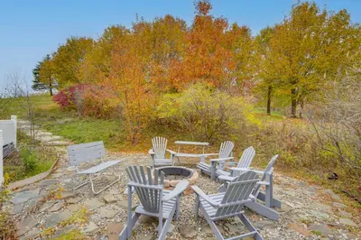 a group of chairs and a table with a fire pit at Expansive Upstate Home with Home Theater! in East Schodack