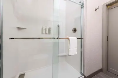 a shower with a glass door in a bathroom at Hampton Inn & Suites Huntington Downtown, Ny in Huntington