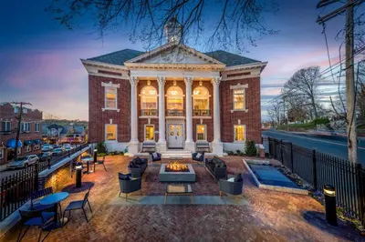 a mansion with a fire pit in front of it at Hampton Inn & Suites Huntington Downtown, Ny in Huntington