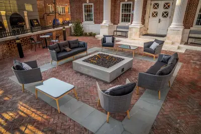 an outdoor patio with chairs and a fire pit at Hampton Inn & Suites Huntington Downtown, Ny in Huntington