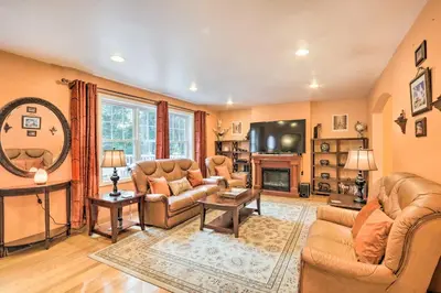 a living room with couches and a tv at Granby Home with Deck Less Than half Mi to Aldrich Lake! in Granby