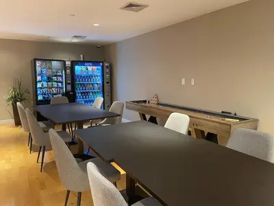 a gaming room with tables and a pool table at National at 888 Sixth Avenue - Furnished Apartments in New York