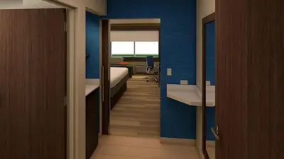 a room with a bedroom with a bed and a mirror at Holiday Inn Express - New Rochelle by IHG in New Rochelle
