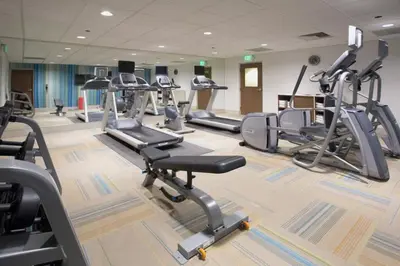a gym with several treadmills and cardio machines at Holiday Inn Express - New Rochelle by IHG in New Rochelle