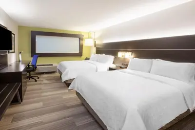 a hotel room with two beds and a flat screen tv at Holiday Inn Express - New Rochelle by IHG in New Rochelle