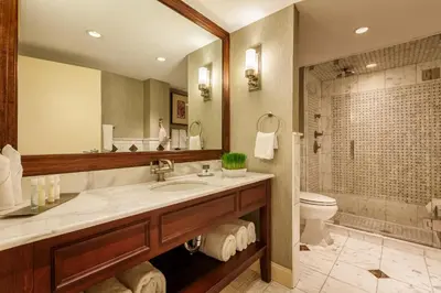 a bathroom with a sink and a toilet and a mirror at Sleepy Hollow Hotel in Tarrytown