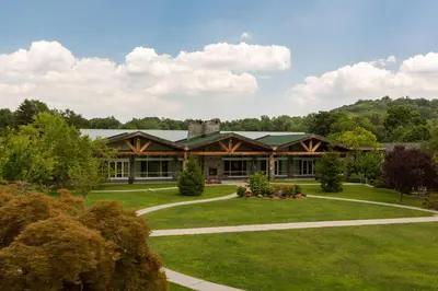 a large house with a green lawn in front of it at Sleepy Hollow Hotel in Tarrytown