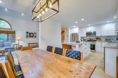 a kitchen and dining room with a large wooden table at Spacious Dover Refuge about 5 Mi to Mount Snow! in Dover