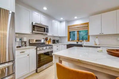 a kitchen with white cabinets and a counter top at Spacious Dover Refuge about 5 Mi to Mount Snow! in Dover
