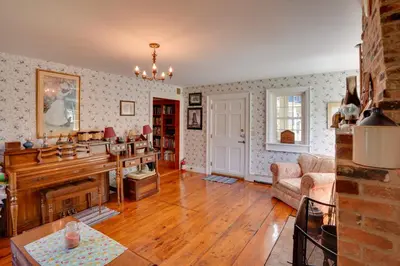 a living room with a piano and a couch at Waterfalls and Trails at The Mills At Green Hole in Hillsdale