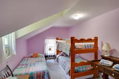 a bedroom with two bunk beds and a ladder at Waterfalls and Trails at The Mills At Green Hole in Hillsdale
