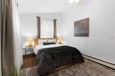 a white bedroom with a bed and a window at New Stylish Beach Home near Stamford Downtown/Cove Beach/ 40 min to NYC in Stamford