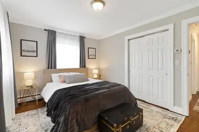 a bedroom with a bed and a large white door at New Stylish Beach Home near Stamford Downtown/Cove Beach/ 40 min to NYC in Stamford