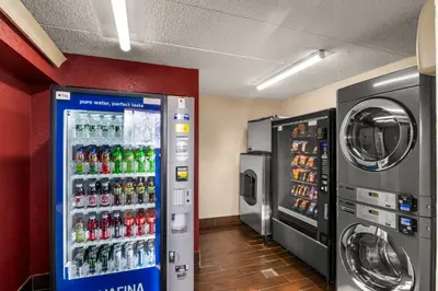 a soda machine in a room next to a washing machine at Red Roof Inn Enfield in Enfield