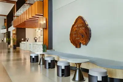 a bar with stools and a sign on a wall at The Westin Jersey City Newport in Jersey City