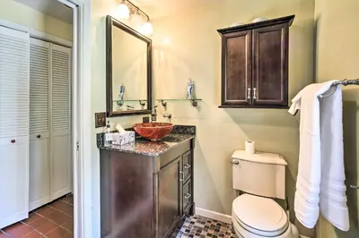 a bathroom with a sink and a toilet and a mirror at Pet-Friendly Latham Retreat about 7 Mi to Albany! in Latham