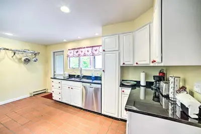 a kitchen with white cabinets and a tile floor at Pet-Friendly Latham Retreat about 7 Mi to Albany! in Latham