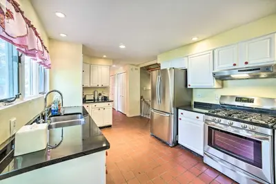 a kitchen with white cabinets and stainless steel appliances at Pet-Friendly Latham Retreat about 7 Mi to Albany! in Latham