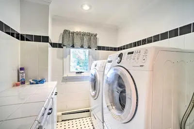 a washer and dryer in a white laundry room at Pet-Friendly Latham Retreat about 7 Mi to Albany! in Latham